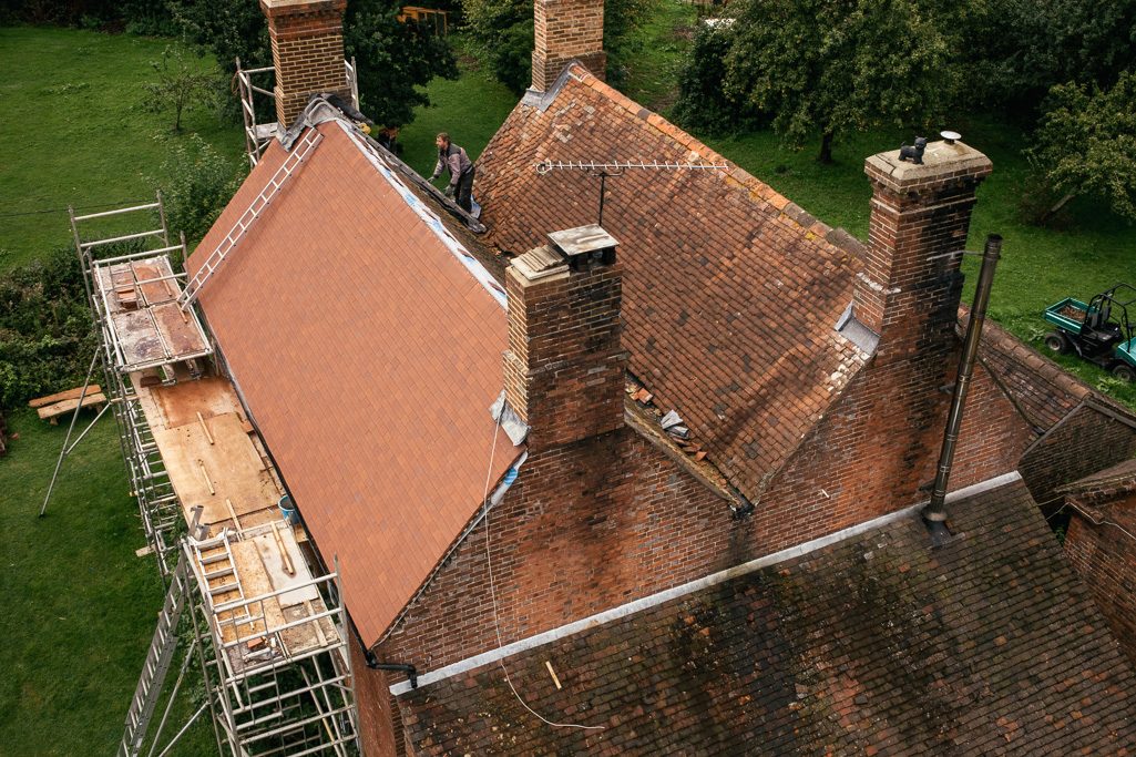 Photo Aerial views of the family farm. Roof repairs on an estate cottage.