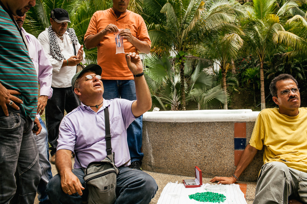 Photo An Emerald buyer sifts through a bag of lower quality emeralds, to get an idea of their average quality and what they are worth. 