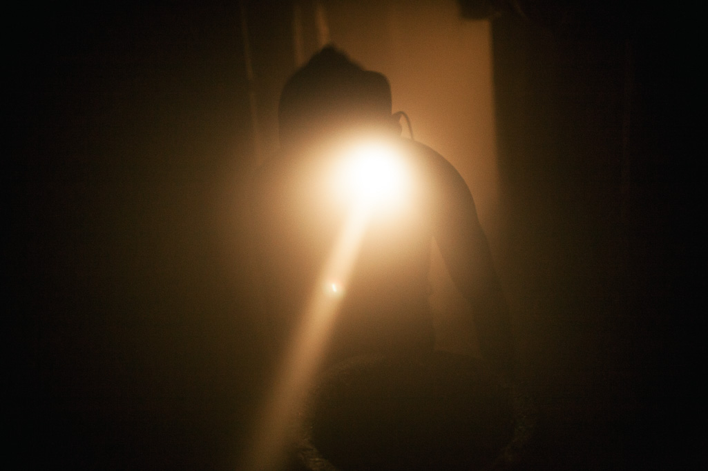 Photo A miner pushes a trolley down the La Paz mine in Coscuez. 