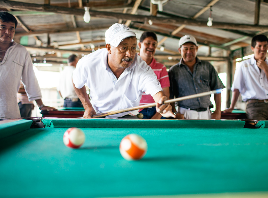 Photo Miners and emerald traders play pool in the encampment in between shifts. 