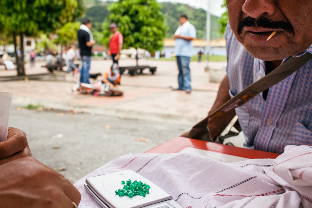 Photo A local emerald trader inspects the quality of a handful of stones in the town of Muzo. 